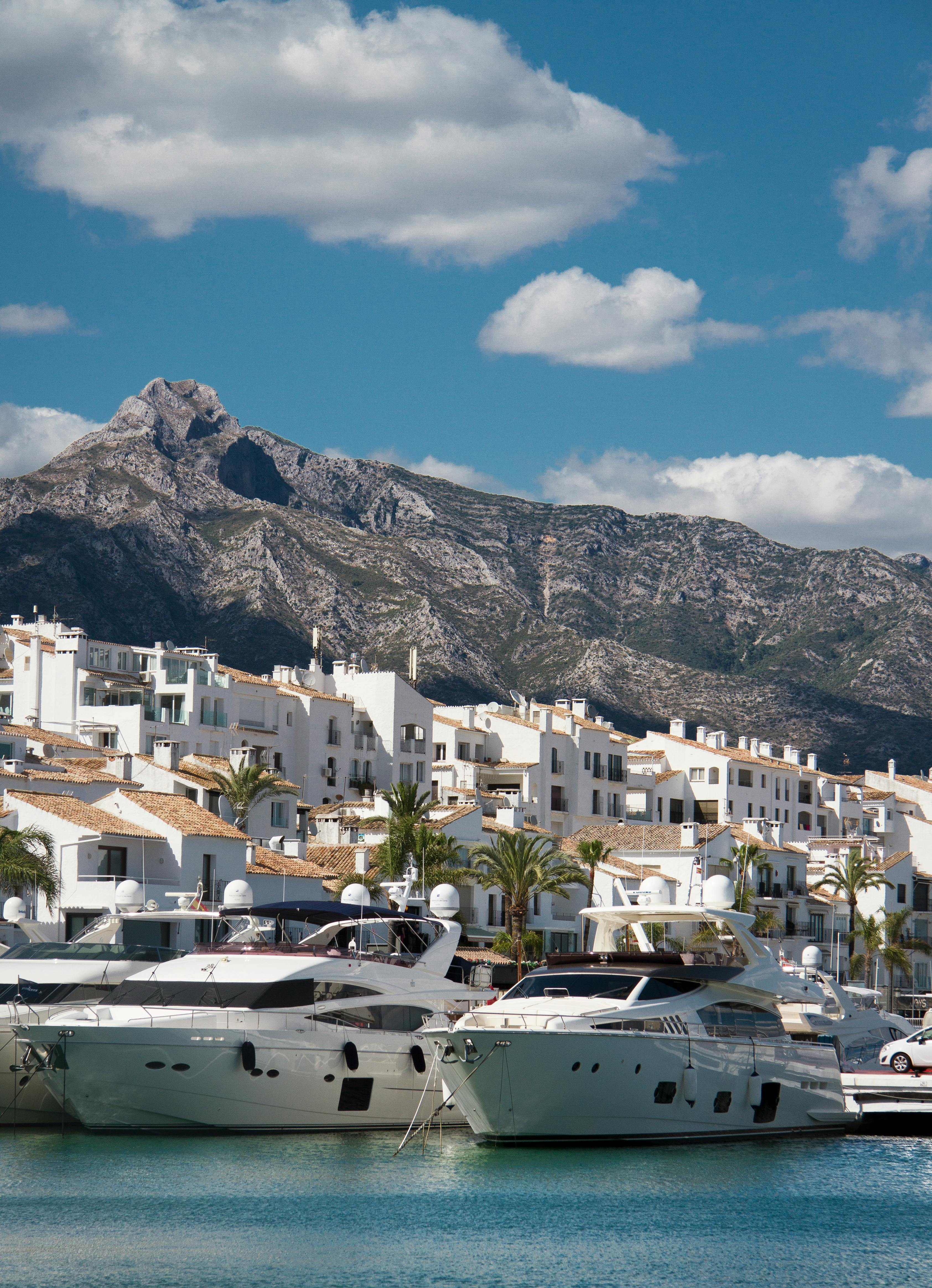 A luxury motor yacht cruising the Mediterranean sea near the coast of Marbella.