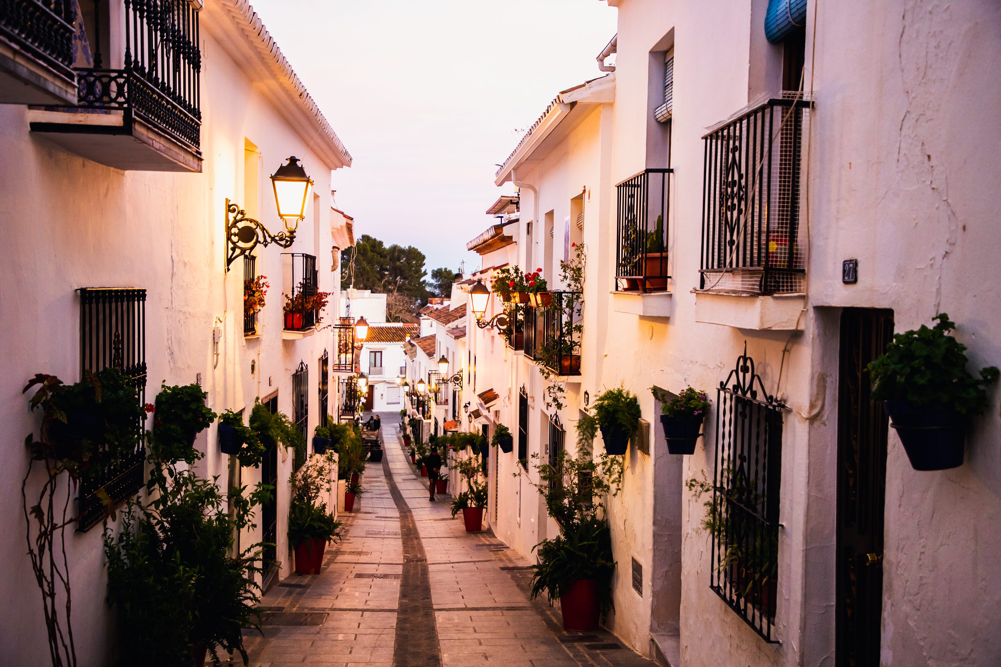 Picturesque view of Mijas Pueblo white village with flower-lined walls and traditional Andalusian charm.