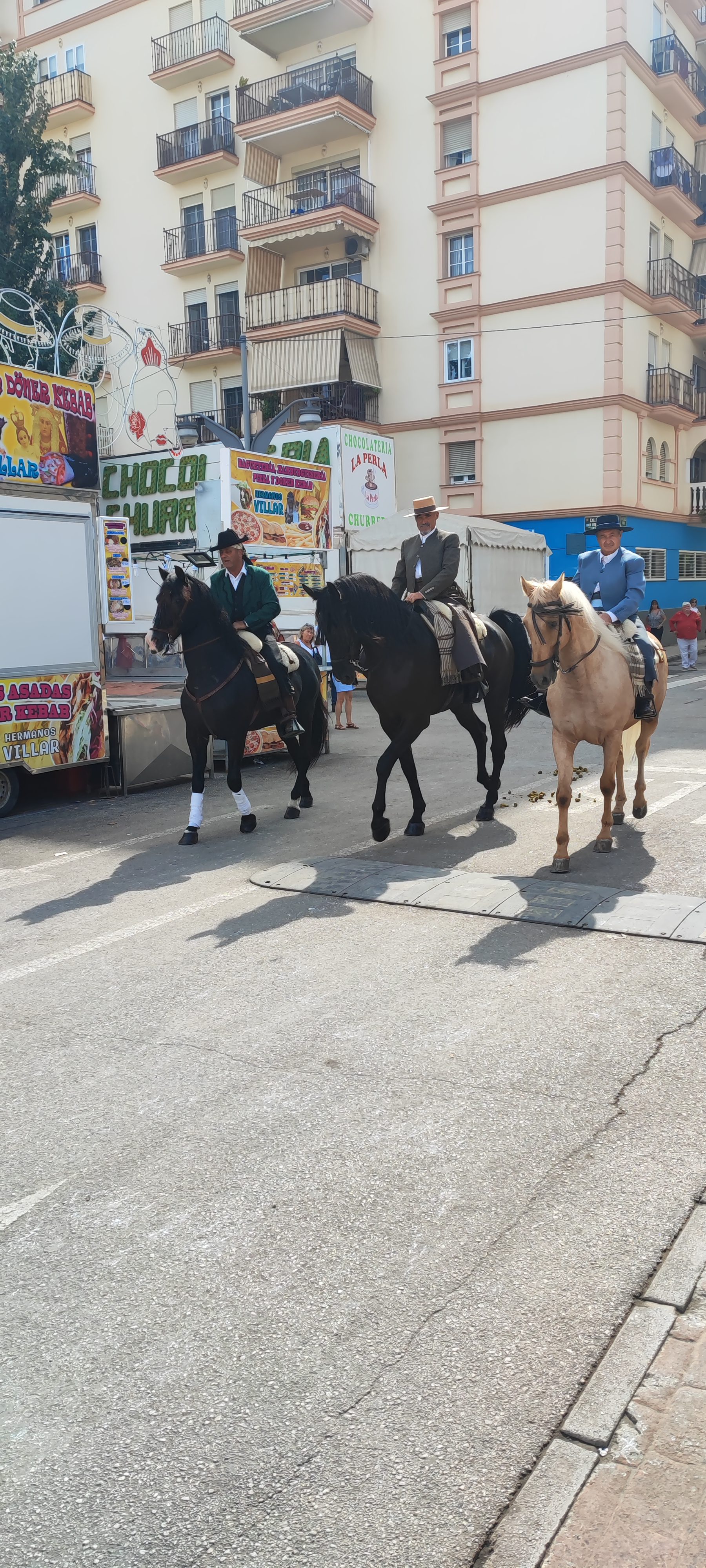 Beautiful Andalusian horses with riders in traditional attire at the Feria de Fuengirola, one of the best cultural festivals in Costa del Sol.