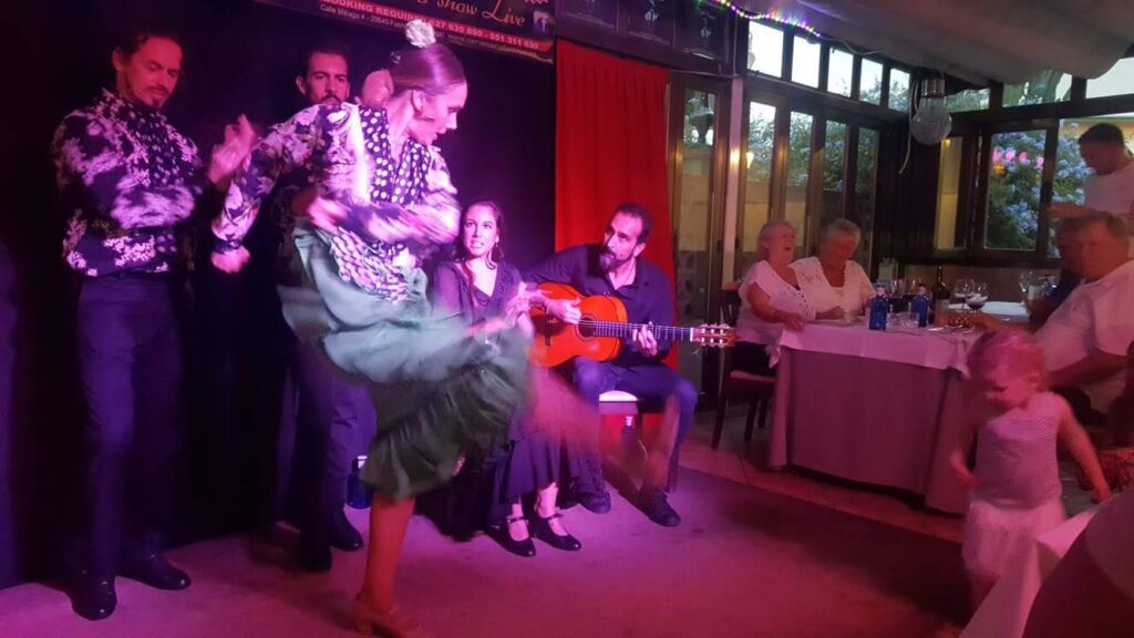 Young girl participating in an interactive flamenco show, one of the best family-friendly activities in Costa del Sol.