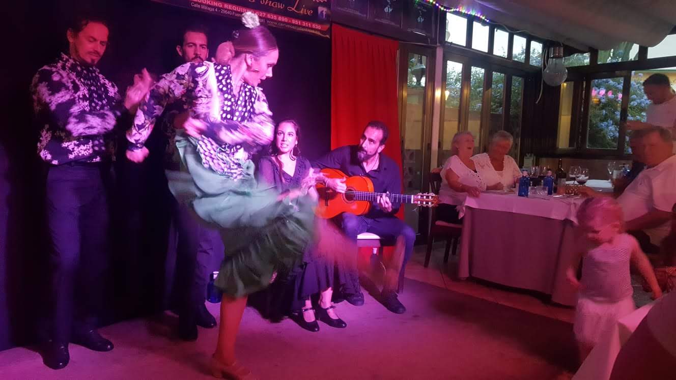 Young girl participating in an interactive flamenco show, one of the best family-friendly activities in Costa del Sol.