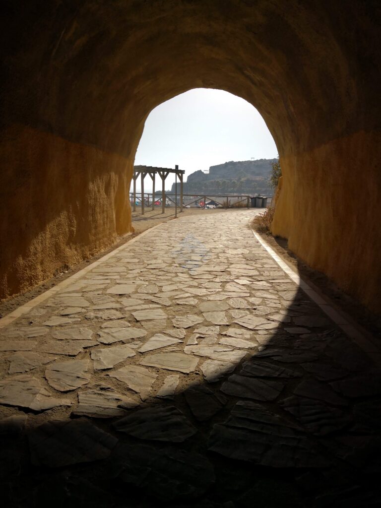 Looking out from inside the historic El Cantal cliff tunnels at the beach in Rincón de la Victoria.